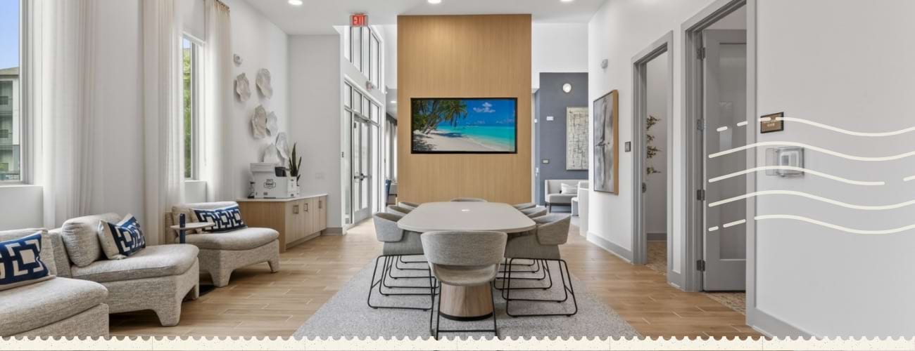 a clubroom with a tv, tables and chairs