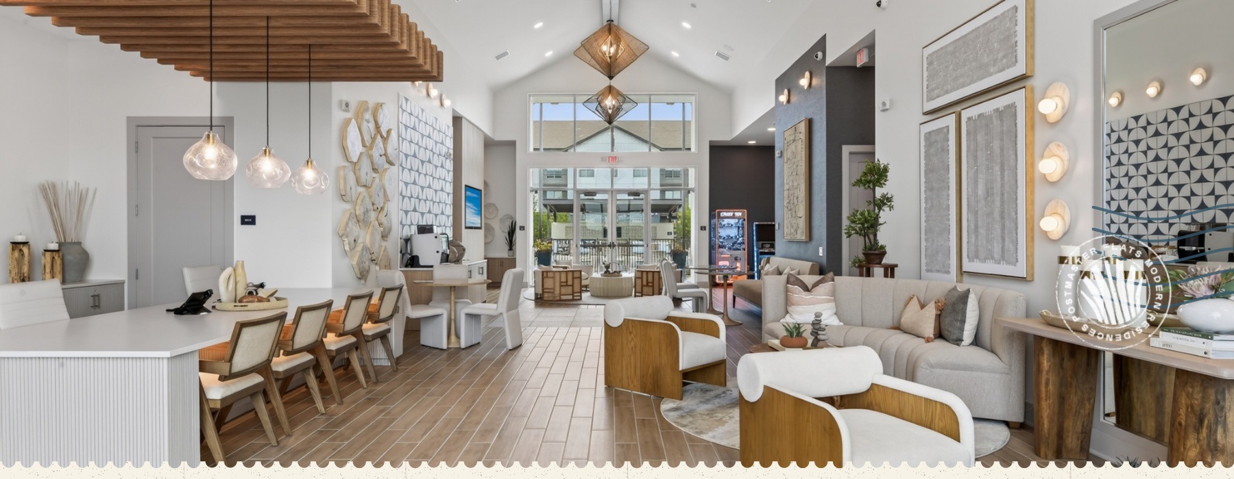 lounge with seating tables chandelier and windows