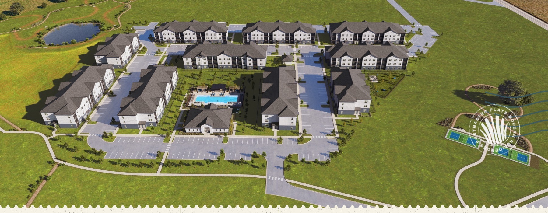 aerial view of an apartment complex surrounded by grass and a pickleball court close by
