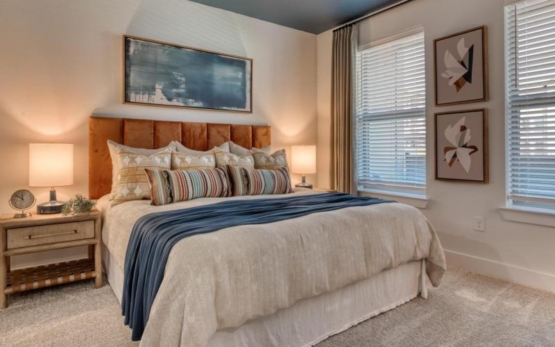 a bedroom with a bed and lamps